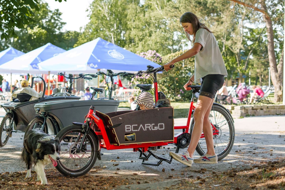 Mom parking cargobike bike bcargo with kid and a dog